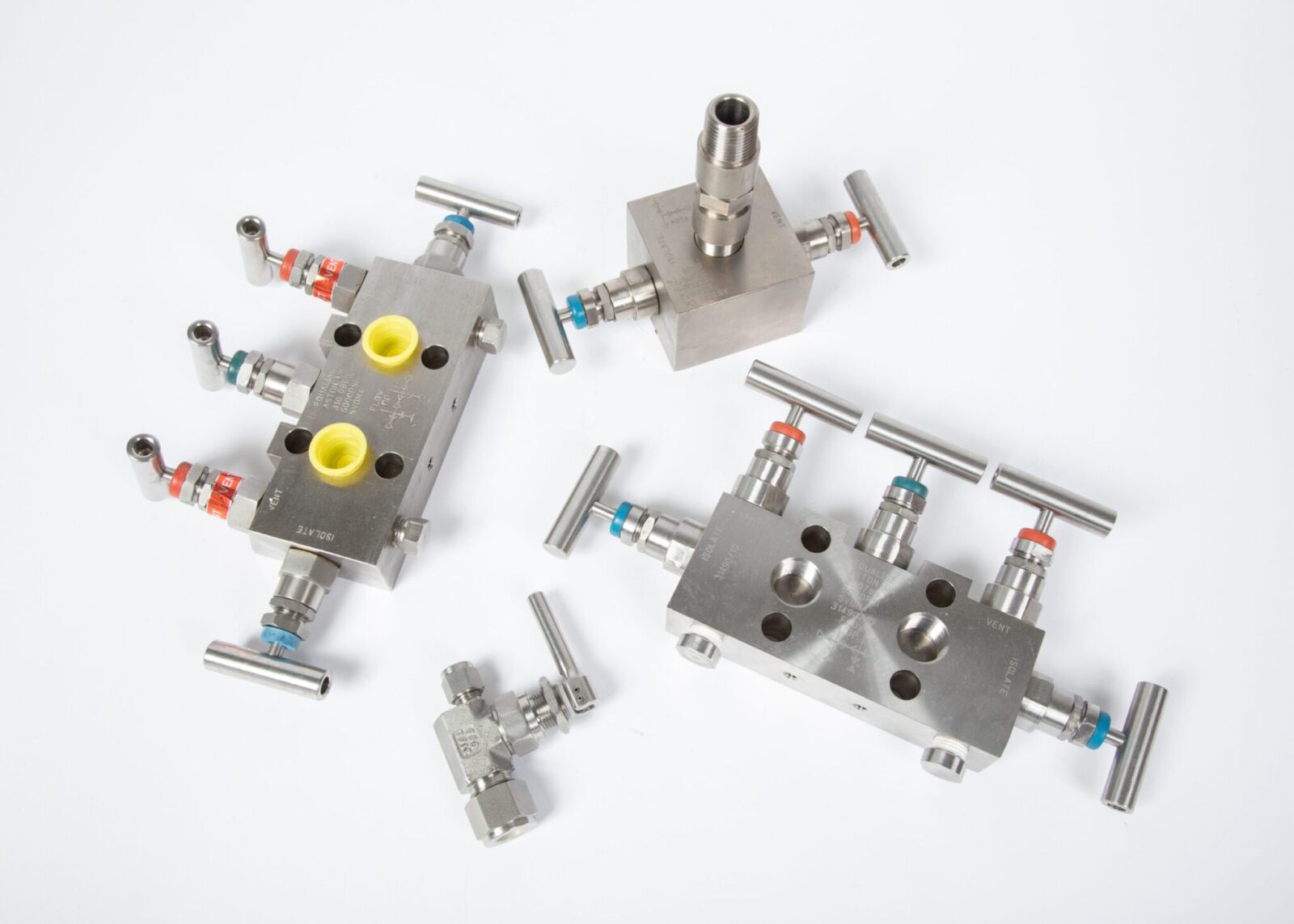 Stainless steel indsutrial manifold fittings on a white background