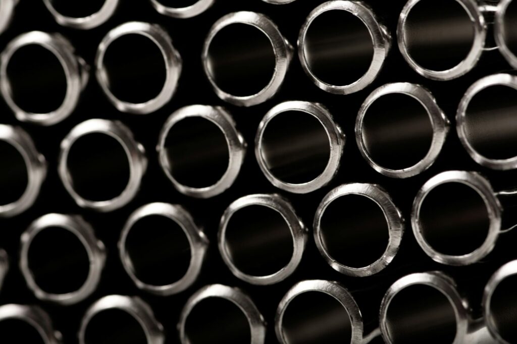 Close-up of stacked steel pipes for industrial construction and fabrication