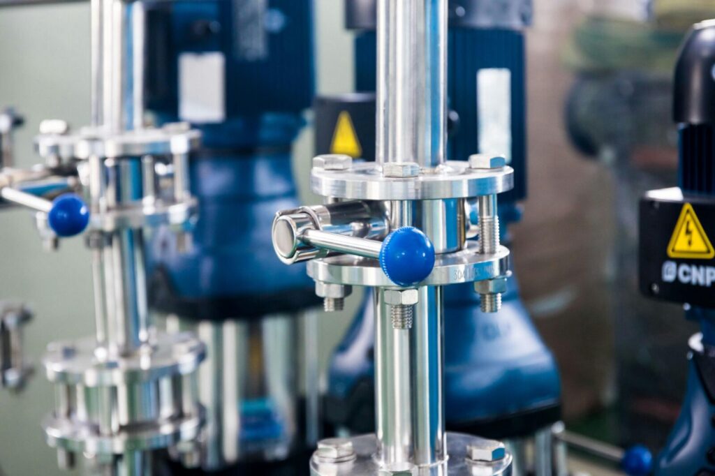 Industrial stainless steel valve and piping system with control handle in factory setting